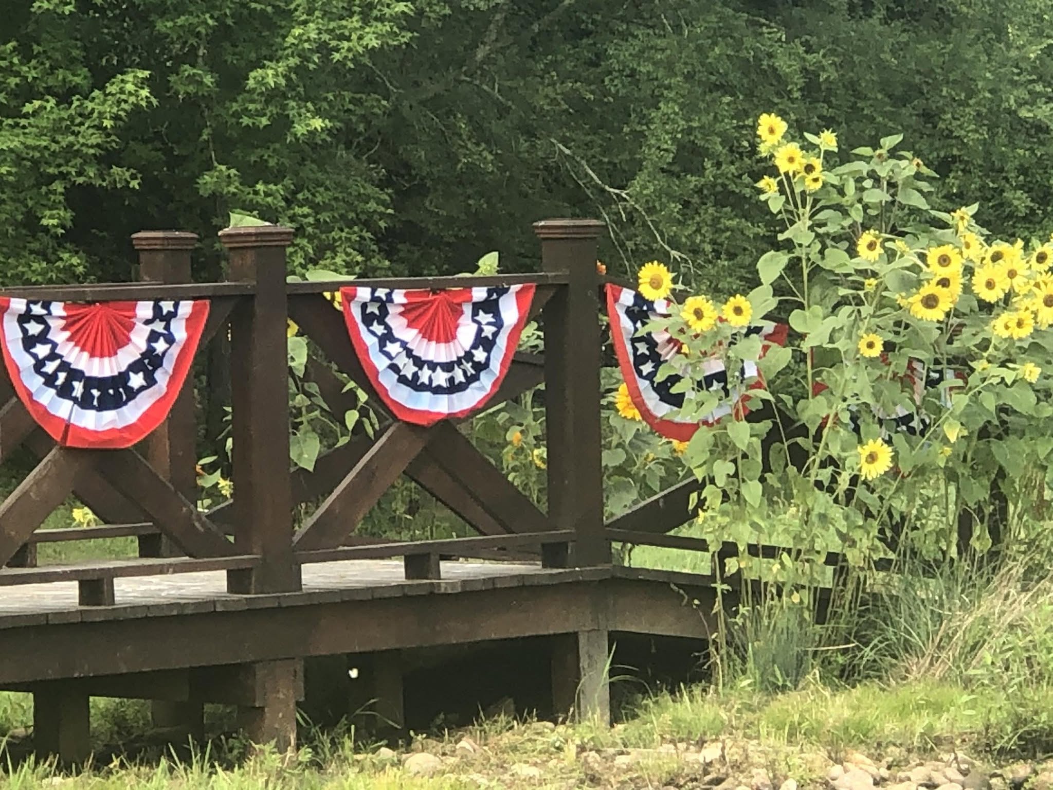 Sunflowers and bunting along the bridge rail in summer